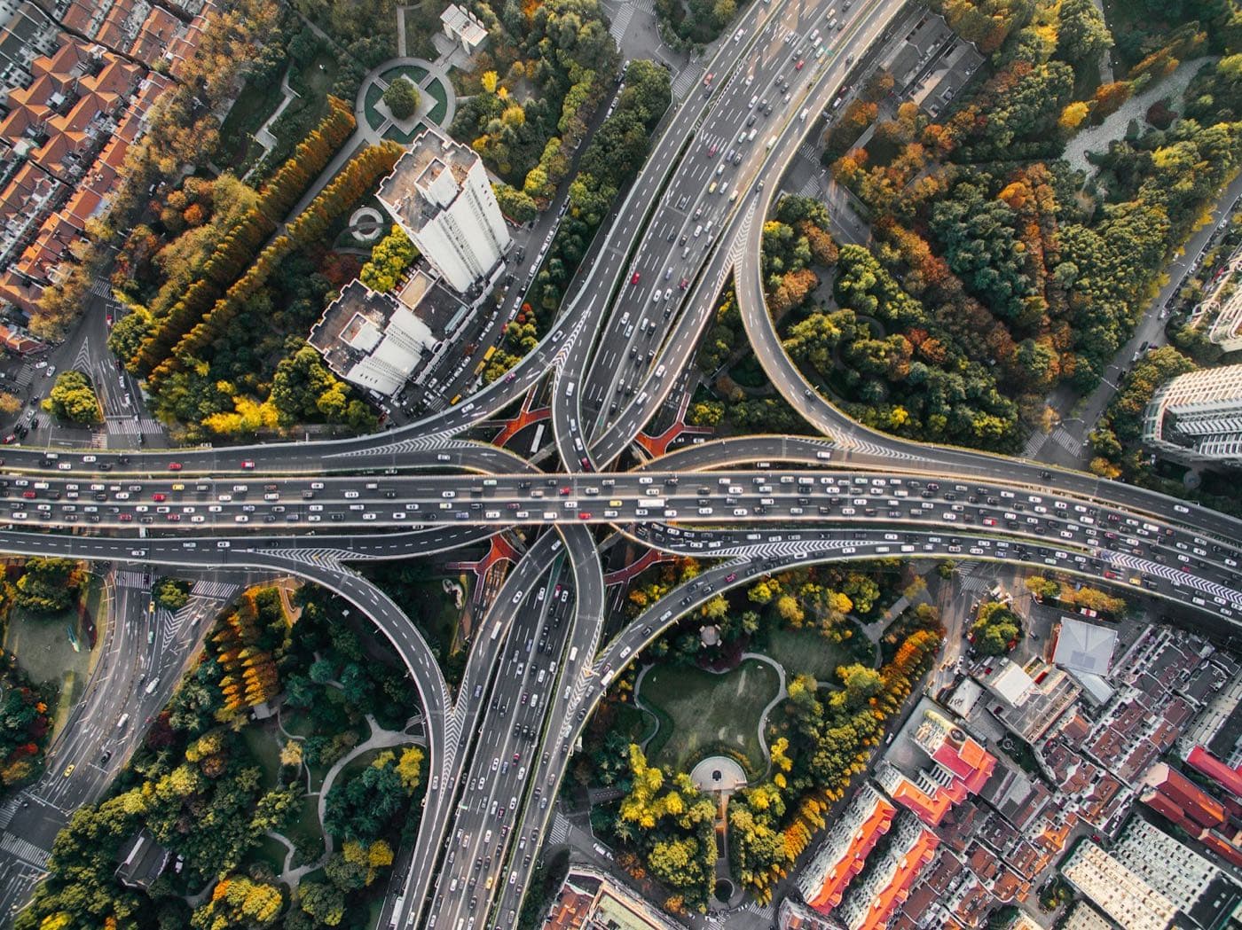 Aerial view of a busy multi-level highway interchange full of cars